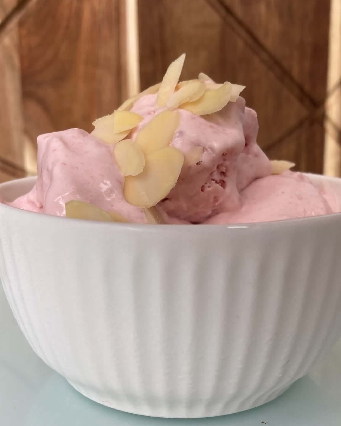 Ice cream with raspberries and chopped almonds